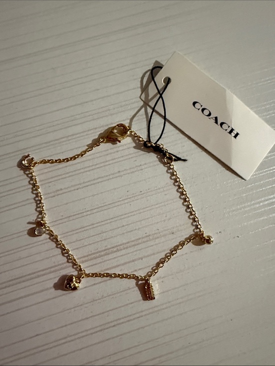 Coach Jewelry - This is a Coach Mini Icons gold-tone charm bracelet. NWT $128